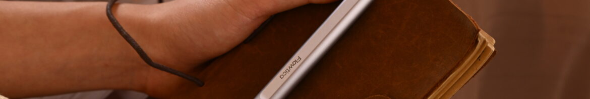 Female holding leather journal silver pen clipped lap